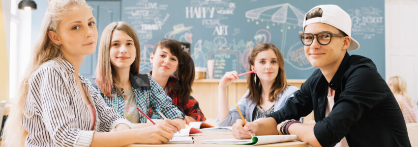 group-students-posing-table